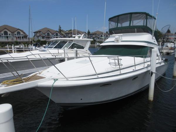 Slide: The Image of 1986 Trojan 11 Meter Convertible yacht docked at a marina. - 0