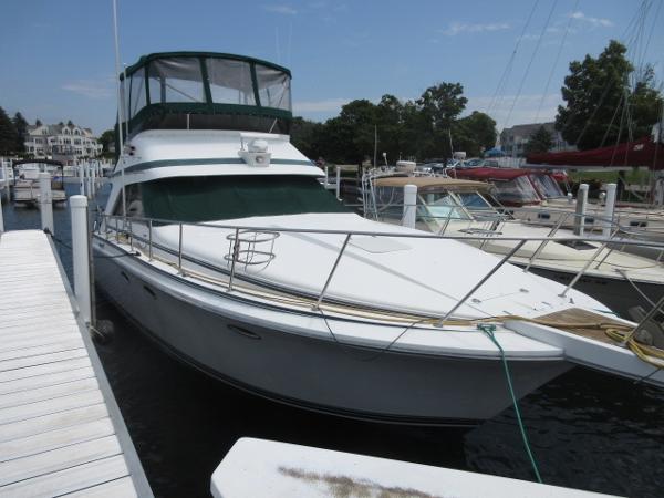 Slide: The Image of 1986 Trojan 11 Meter Convertible yacht docked at a marina. - 1