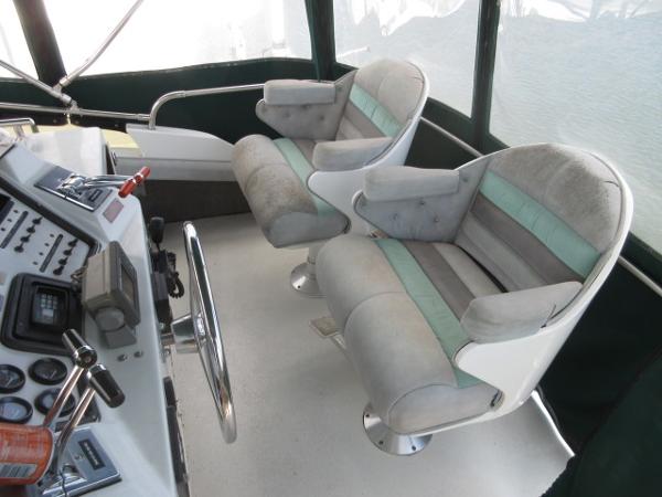 Slide: The Image of 1986 Trojan 11 Meter Convertible boat cockpit with dual captain chairs. - 10