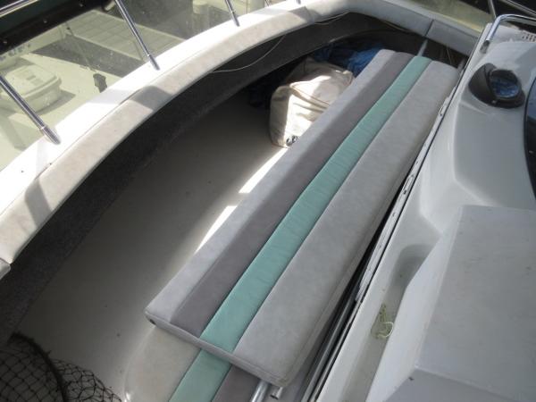 Slide: The Image of 1986 Trojan 11 Meter Convertible boat interior with cushioned seating. - 11