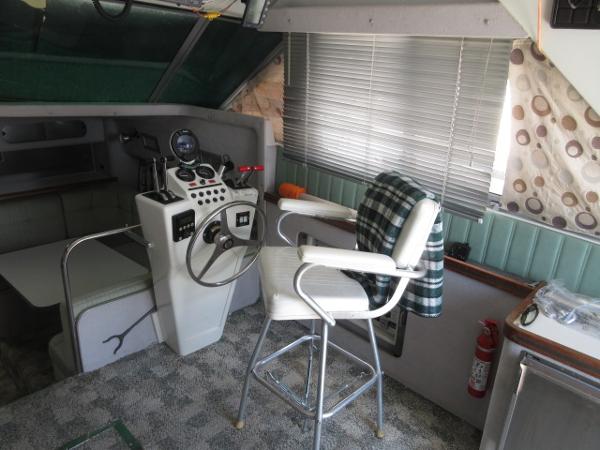Slide: The Image of 1986 Trojan 11 Meter Convertible boat interior with helm station and captain's chair. - 14
