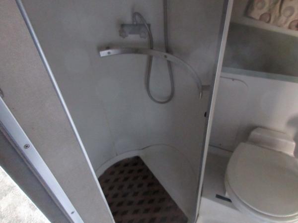 Slide: The Image of 1986 Trojan 11 Meter Convertible boat bathroom with shower and toilet. - 24