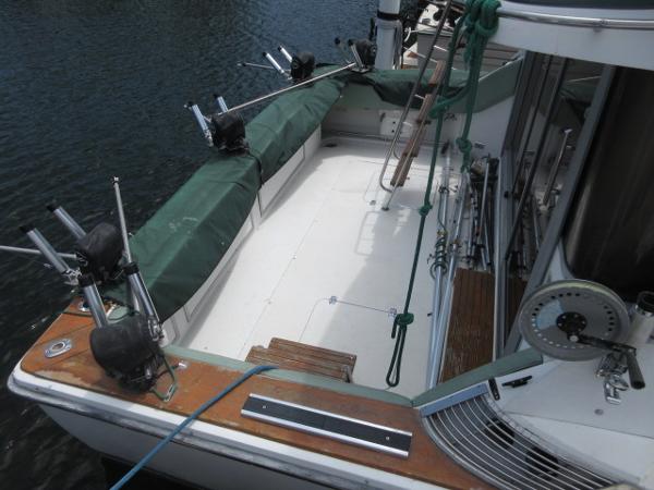 Slide: The Image of 1986 Trojan 11 Meter Convertible boat deck with fishing rod holders. - 3