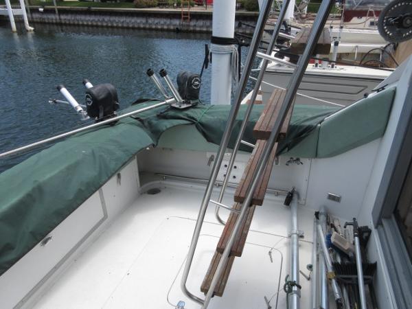 Slide: The Image of 1986 Trojan 11 Meter Convertible boat deck with fishing equipment. - 7