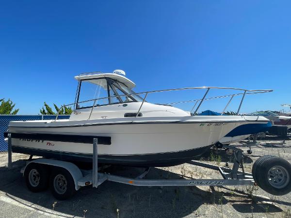 Slide: The Image of 2003 Trophy 2052 Walkaround boat on a trailer under clear blue sky. - 0