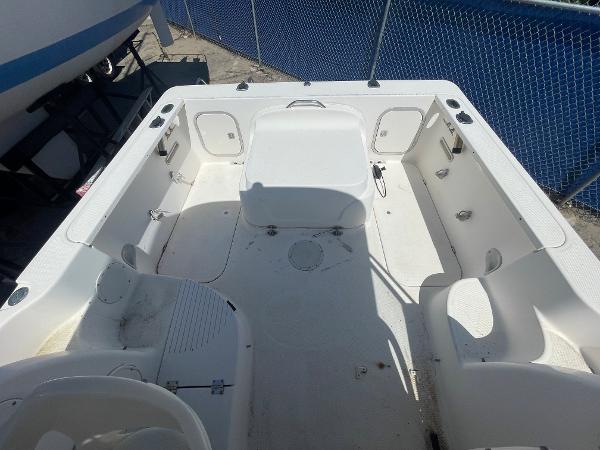 Slide: The Image of 2003 Trophy 2052 Walkaround boat interior, spacious deck with seating and storage compartments. - 11