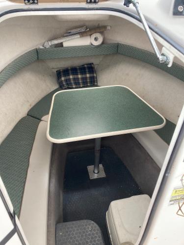 Slide: The Image of 2003 Trophy 2052 Walkaround cabin interior with table and seating. - 13