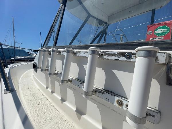 Slide: The Image of 2003 Trophy 2052 Walkaround boat with rod holders and windshield. - 7