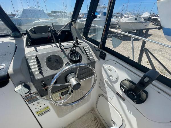 Slide: The Image of 2003 Trophy 2052 Walkaround boat cockpit with steering wheel and control panel. - 9