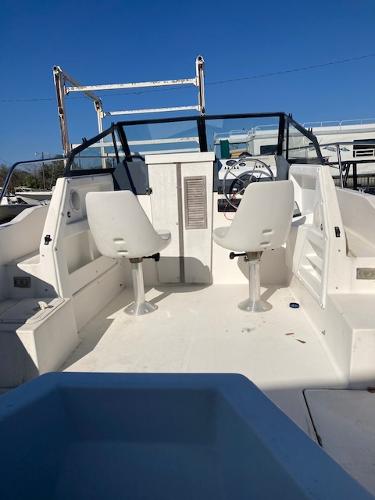 Slide: The Image of 1997 Trophy BAYLINER WALK AROUND boat interior with two white captain chairs. - 3
