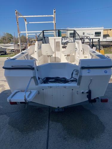 Slide: The Image of 1997 Trophy BAYLINER WALK AROUND boat, rear view, docked on concrete. - 4