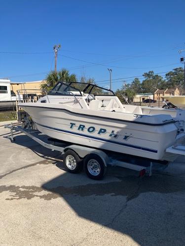 Slide: The Image of 1997 Trophy BAYLINER WALK AROUND boat on a trailer in a sunny outdoor setting. - 5