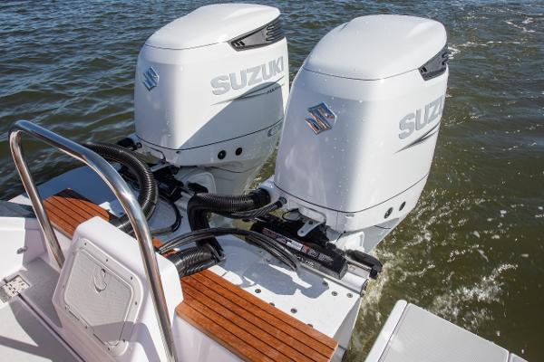 Slide: The Image of Twin Suzuki outboard motors on 2024 True North 34 boat in water. - 14