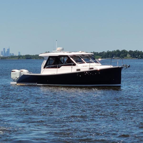 Slide: The Image of 2024 True North 34 boat cruising on a sunny day. - 25