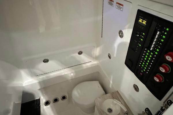 Slide: The Image of 2022 Valhalla V-33 Center Console interior with control panel and toilet. - 25