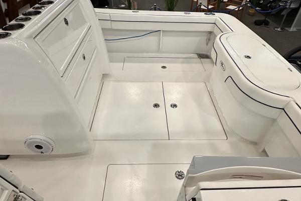 Slide: The Image of 2022 Valhalla V-33 Center Console boat interior with storage compartments and seating. - 26