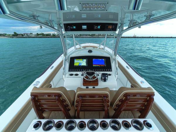 Slide: The Image of 2025 Valhalla Boatworks V-37 helm with advanced navigation systems and luxurious seating on open water. - 13