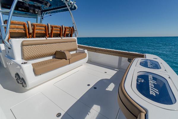 Slide: The Image of 2025 Valhalla Boatworks V-46, luxurious seating, open deck, ocean backdrop. - 12
