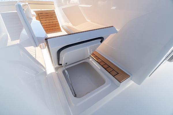 Slide: The Image of 2025 Valhalla Boatworks V-46 interior with open storage compartment and wooden accents. - 16