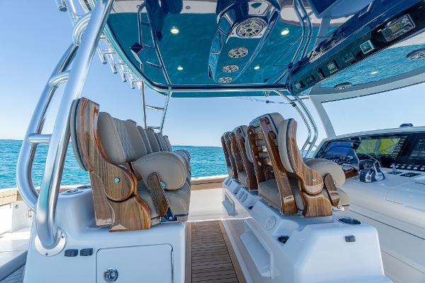 Slide: The Image of 2025 Valhalla Boatworks V-46 interior with luxurious seating and advanced controls on open water. - 17