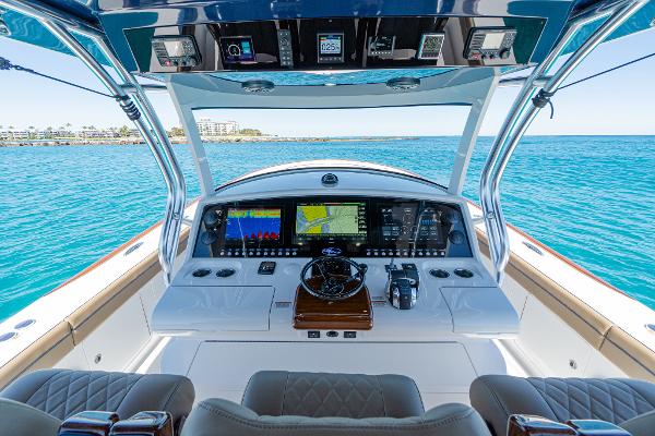Slide: The Image of 2025 Valhalla Boatworks V-46 helm with advanced navigation systems on open water. - 19