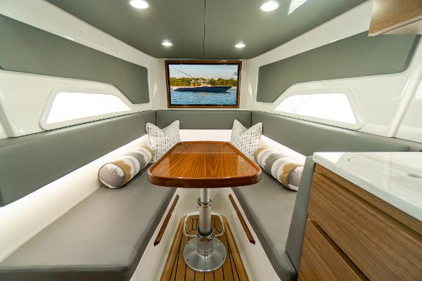 Slide: The Image of Luxurious interior of 2025 Valhalla Boatworks V-46 with elegant seating and wooden table. - 21