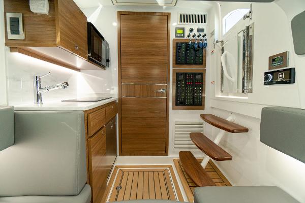 Slide: The Image of 2025 Valhalla Boatworks V-46 interior with modern kitchen and control panel. - 23