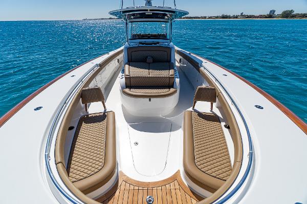 Slide: The Image of 2025 Valhalla Boatworks V-46 luxury boat interior with tan seating on blue ocean. - 31