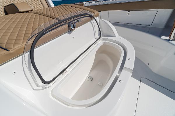 Slide: The Image of 2025 Valhalla Boatworks V-46 open storage compartment with tan quilted seating. - 35