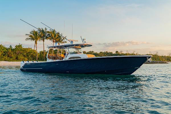 Slide: The Image of 2025 Valhalla Boatworks V-46 cruising near tropical shoreline at sunset. - 7