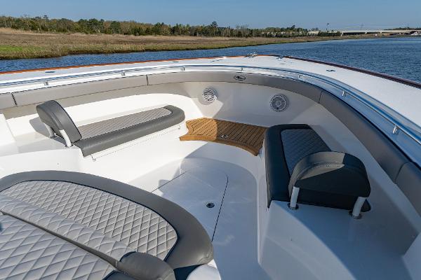 Slide: The Image of 2025 Valhalla Boatworks V-55 bow seating area with luxurious upholstery and scenic water view. - 13