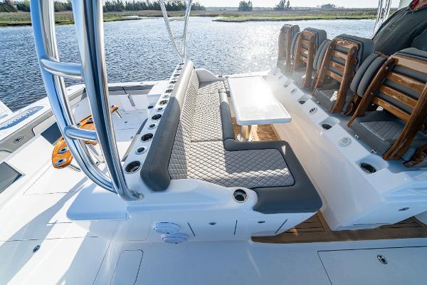 Slide: The Image of 2025 Valhalla Boatworks V-55 interior seating area with table on a sunny day. - 9