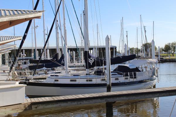 Slide: The Image of Valiant 42 sailboat docked at marina, 1996 model, calm waters, clear sky. - 0