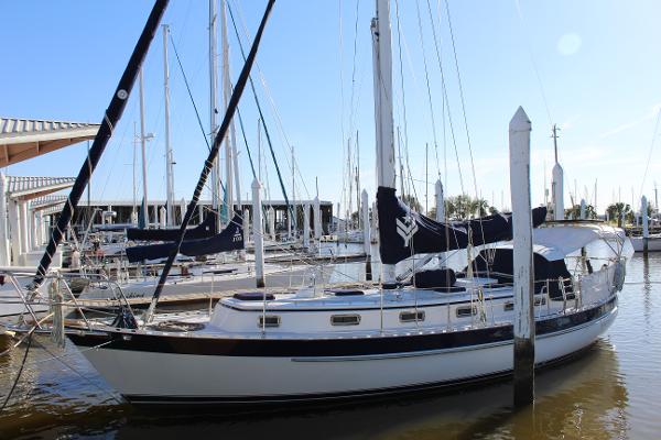 Slide: The Image of 1996 Valiant 42 sailboat docked at a marina on a sunny day. - 1