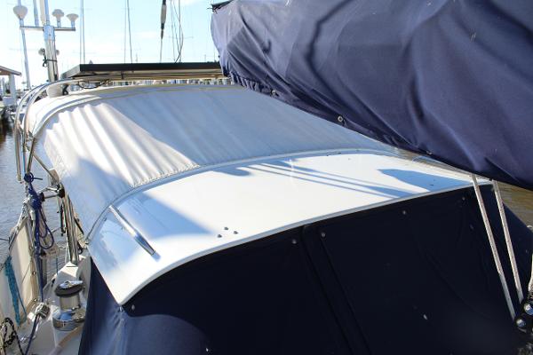 Slide: The Image of 1996 Valiant 42 sailboat with blue and white canvas covers. - 12