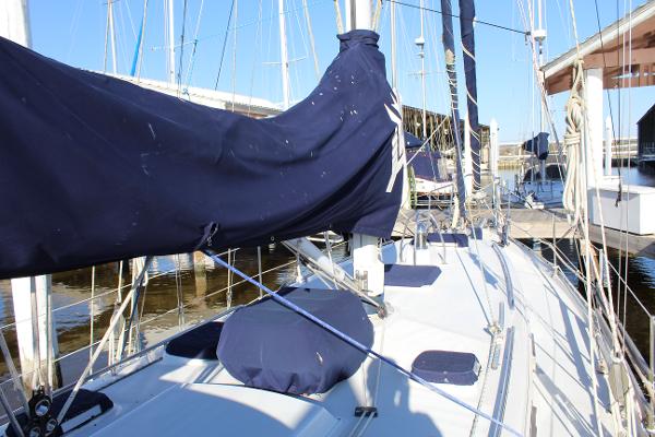 Slide: The Image of Valiant 42 sailboat, 1996 model, docked at marina with blue sail covers. - 14