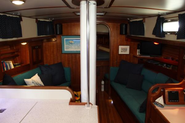 Slide: The Image of Interior of 1996 Valiant 42 sailboat with cozy seating and wooden finishes. - 28