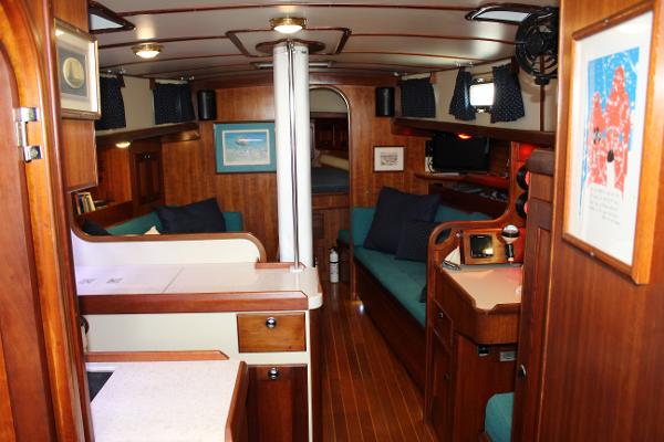 Slide: The Image of Interior of a 1996 Valiant 42 sailboat with wooden furnishings and cozy seating. - 29