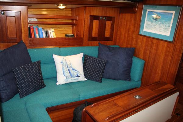 Slide: The Image of Interior of a 1996 Valiant 42 sailboat with teal seating and nautical decor. - 30
