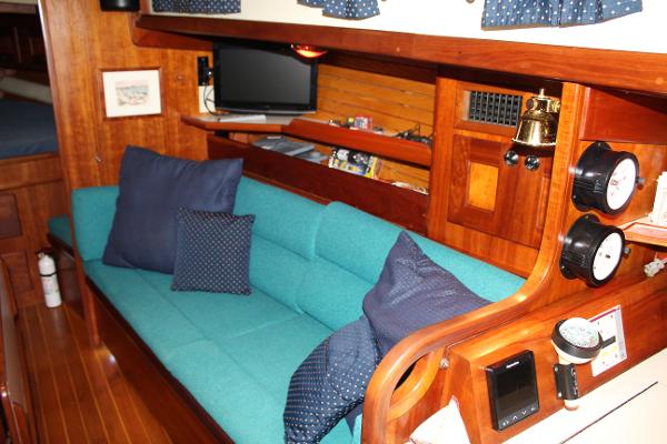 Slide: The Image of Interior of 1996 Valiant 42 sailboat with teal sofa and nautical decor. - 34