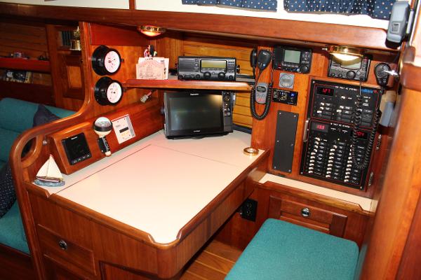 Slide: The Image of Navigation station on a 1996 Valiant 42 sailboat with electronics and control panels. - 40