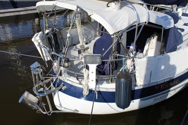 Slide: The Image of 1996 Valiant 42 sailboat docked, rear view with equipment and canopy. - 8