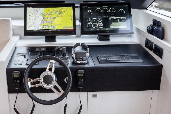 Slide: The Image of 2026 Van der Valk Beach Club 600 yacht helm with dual Garmin displays and modern controls. - 44