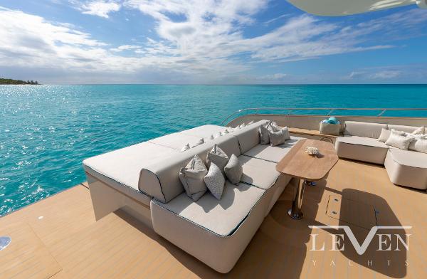 Slide: The Image of Luxurious Van der Valk LeVen 90 yacht deck with elegant seating, overlooking serene turquoise waters. - 13