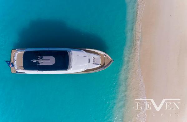 Slide: The Image of Aerial view of 2026 Van der Valk LeVen 90 yacht near a sandy beach. - 2