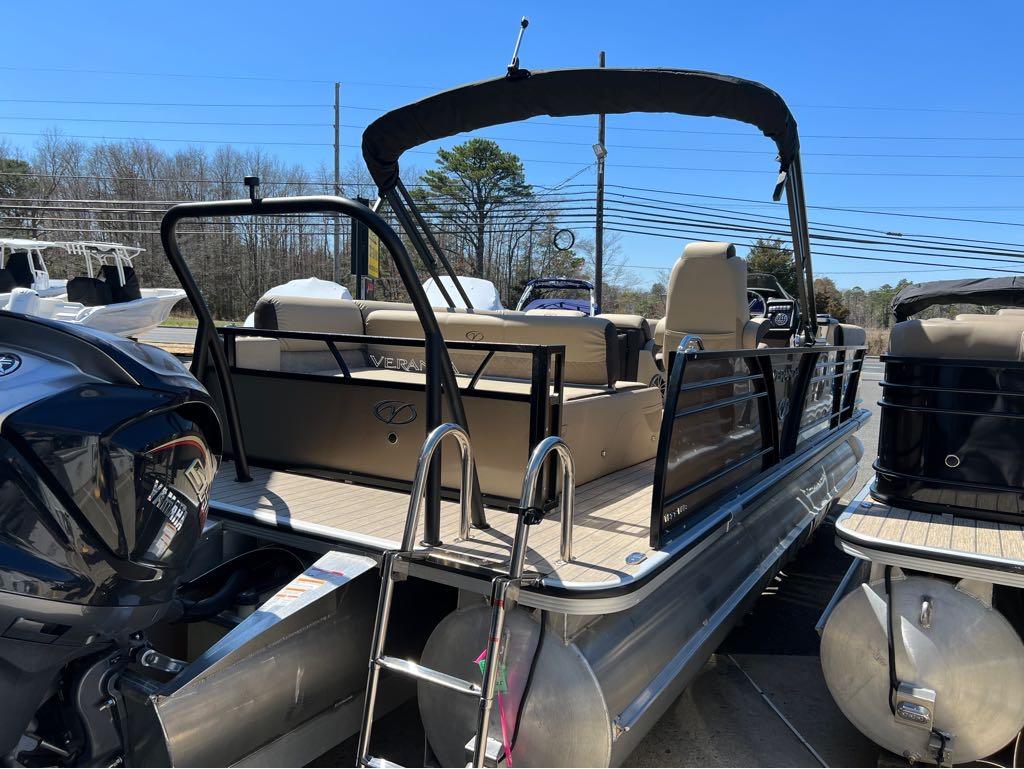 Slide: The Image of 2023 Veranda VP 22 VLB pontoon boat with black railing and outboard motor. - 2