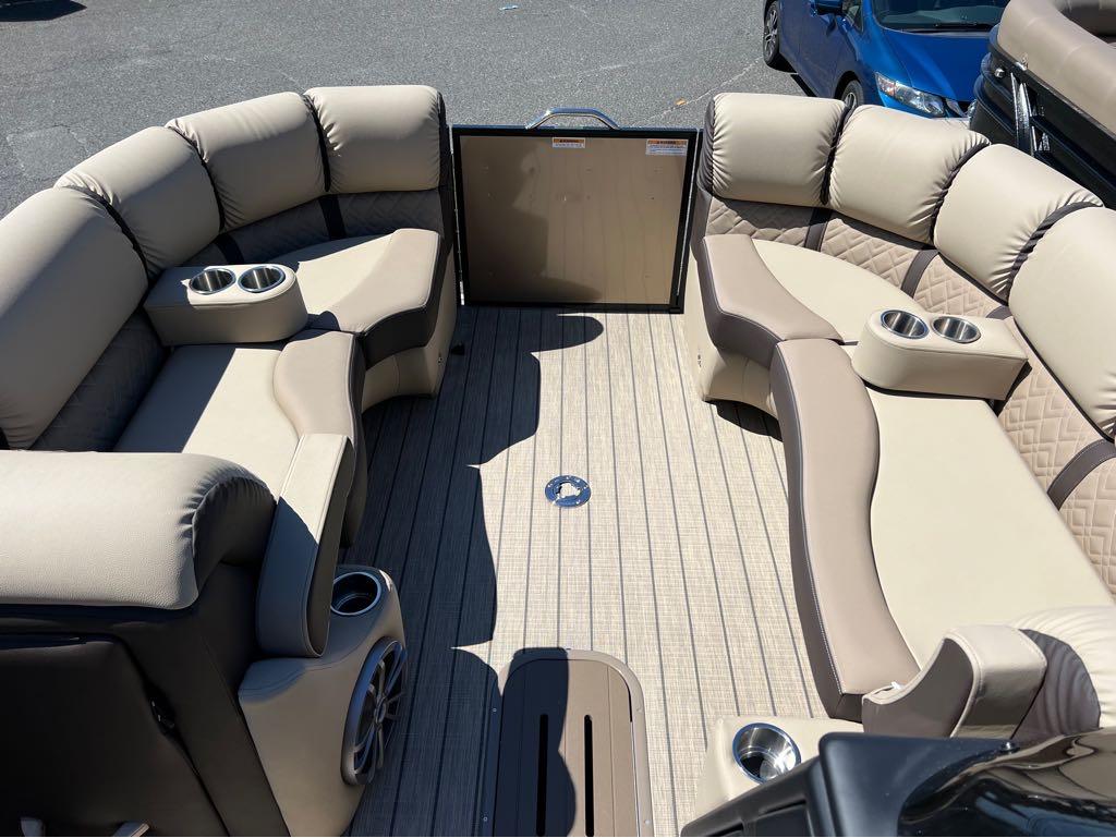 Slide: The Image of 2023 Veranda VP 22 VLB pontoon boat interior with beige cushioned seating and cup holders. - 21