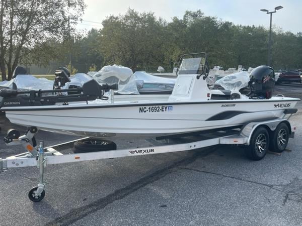 Slide: The Image of 2022 Vexus 1980 CC boat on a trailer in a parking lot. - 1
