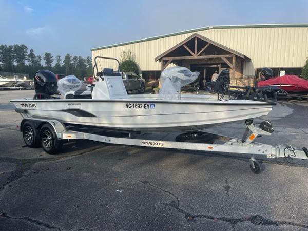 Slide: The Image of 2022 Vexus 1980 CC boat on trailer in front of a building. - 2