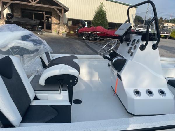 Slide: The Image of 2022 Vexus 1980 CC boat interior with console and seating, parked outside dealership. - 8